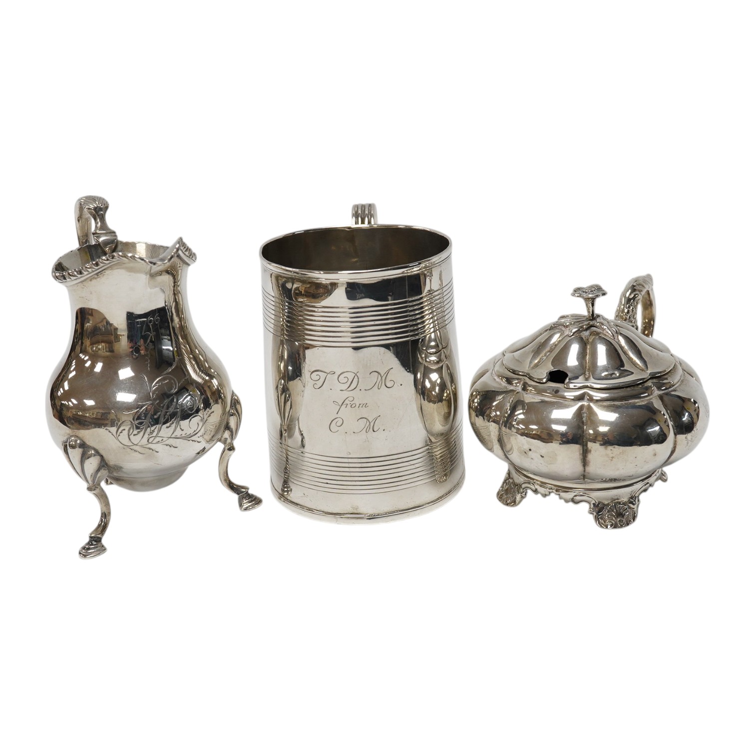 A George III silver cream jug, marks rubbed, a George III silver christening mug, London, 1801 and a William IV silver melon shaped mustard pot, John, Henry & Charles Lias, London, 1835. Condition - poor to fair